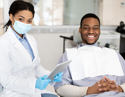 man visiting with dentist about payment options for braces