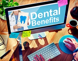 Checking dental benefits on flatscreen computer