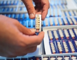 Male dental patient sitting in chair and smiling