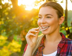 Woman inserting trays while outdoors